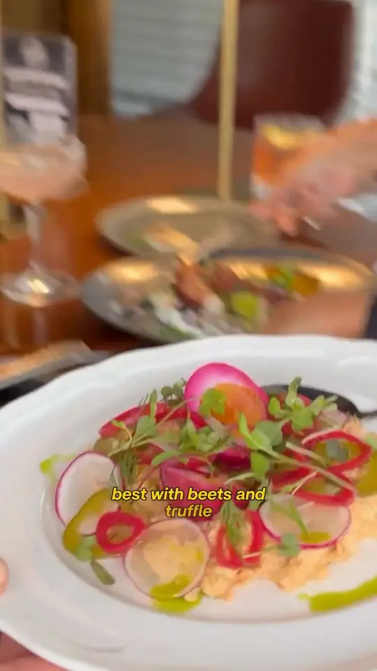 1592 in Sarasota showing food, saganaki flambe grilled octopus, beets and truffle burrata, smoked fish dip, fried zucchini beignets, lamb stuffed grilled eggplant, whole br, video by Nabetsi Travels on Facebook