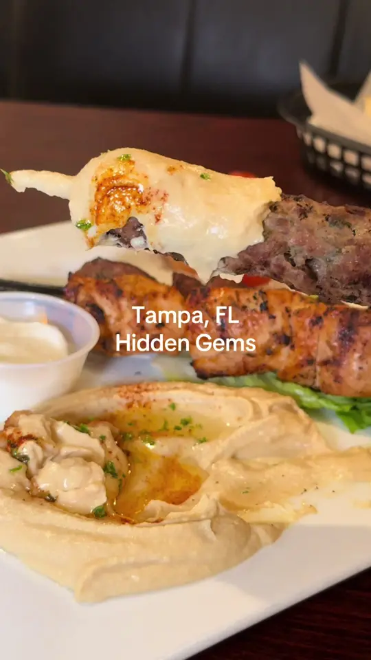 AL Sham Palace in Tampa showing review, special salmon with tahini cream sauce, batata harra, muhammara, arab mixed grill platter, shish kabab, shish kofta, video by tampaiman on TikTok