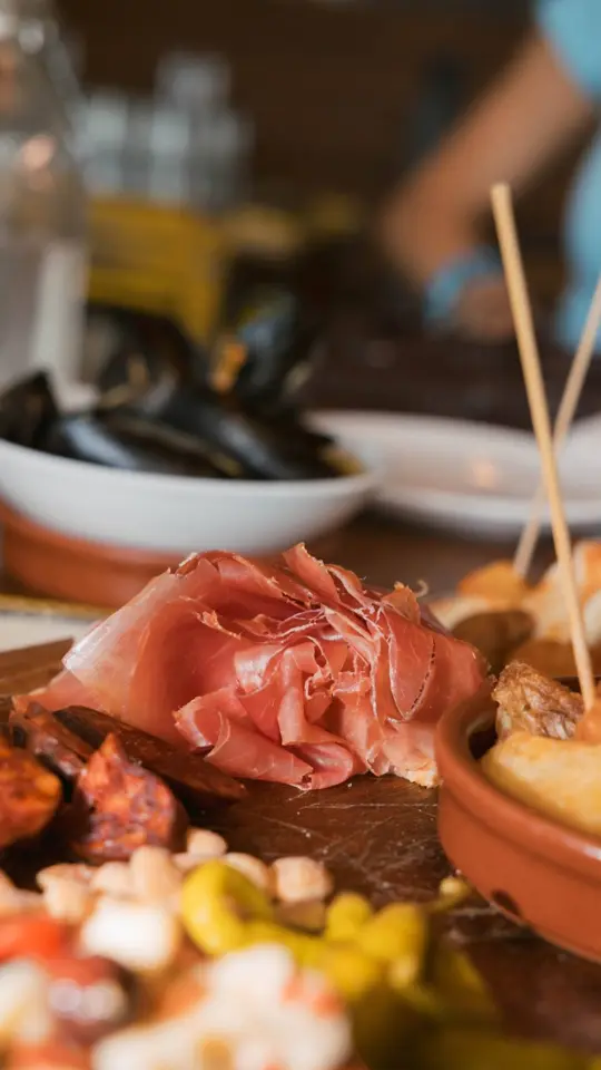 Barcelona Wine Bar in Tampa showing tapas, charcuterie, chicken pimientos, paella mariscos, wine, video by Visit Tampa Bay on Facebook