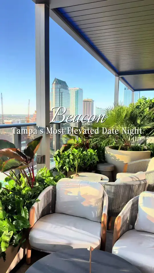 Beacon Tampa Rooftop Lounge in Tampa showing cocktail, heirloom tomato bruschetta, romantic night out, celebratory cocktails, panoramic skyline views, golden hour over the water, video by eatlocalflorida on TikTok