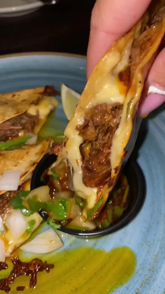 Besito Mexican Restaurant in Tampa showing street tacos, birria tacos, chipotle braised pulled short ribs, melted cheese, consomé dipping sauce, video by feedingtampabaes on TikTok