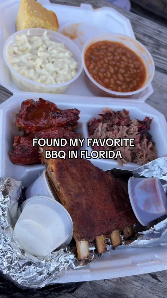 Big Worm's BBQ in Fort Pierce showing food, coleslaw, fried okra, mac & cheese, baked beans, meat sampler platter, corn bread, banana pudding cheesecake, video by foodieberrie on TikTok