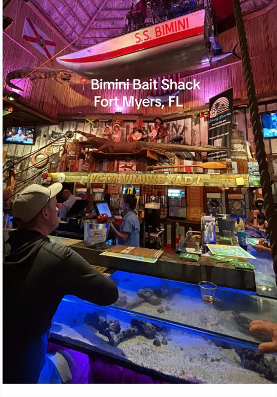 Bimini Bait Shack in Fort Myers showing waterfront dining, fresh seafood, live music, bar made of a fish tank, video by ashleya113 on TikTok