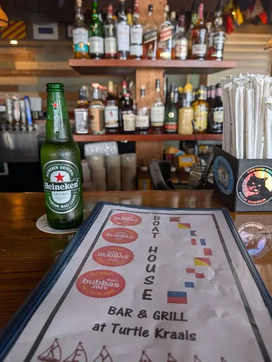 Boat House Bar & Grill in Key West showing happy hour, discounted drinks, small plates, bubba awards, video by Key West Food Guide on Facebook