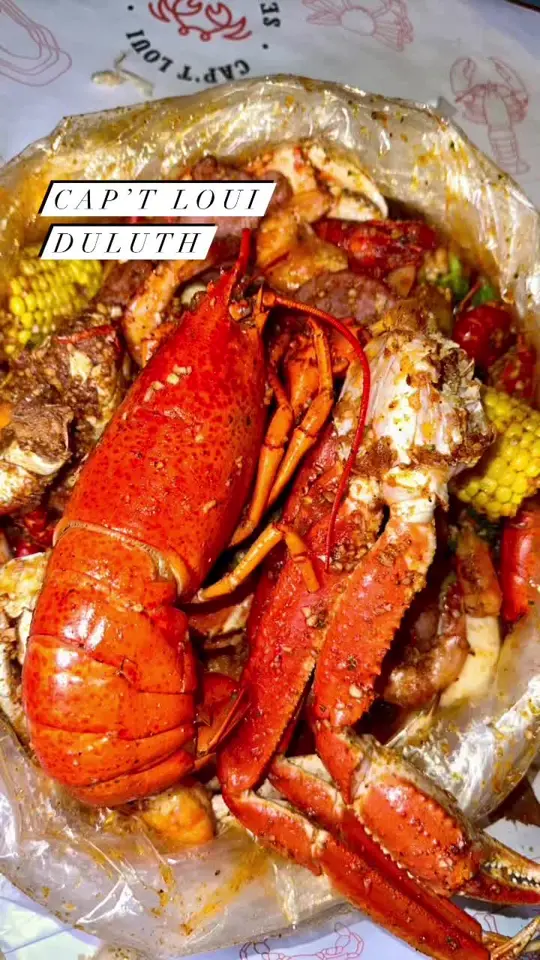 Cap't Loui Duluth in Duluth showing seafood, lobster, snow crab, dungeness crab, shrimp, crawfish, oysters, garlic noodles, video by servinglooksatl on TikTok