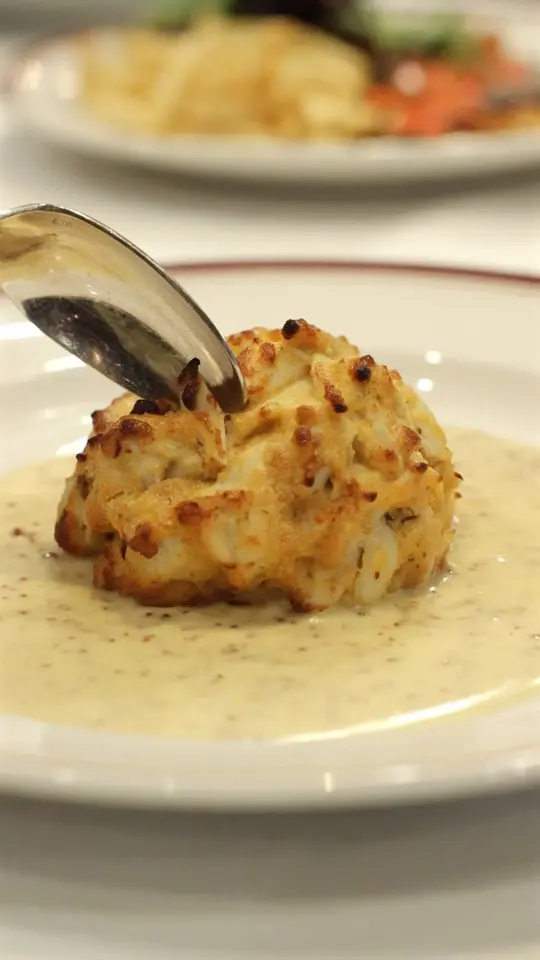 Chops Lobster Bar in Boca Raton showing food, crab cake, video by Chops Lobster Bar on Facebook