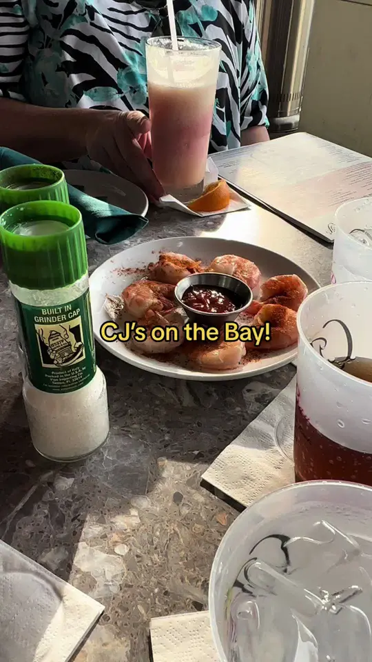 Cj's On The Bay in Marco Island showing review, visit, rum butter mahi mahi, miami vice drink, peel & eat shrimp, diver scallops, ravioli puttanesca, cj's bloody mary, video by mywalksinparadise on TikTok