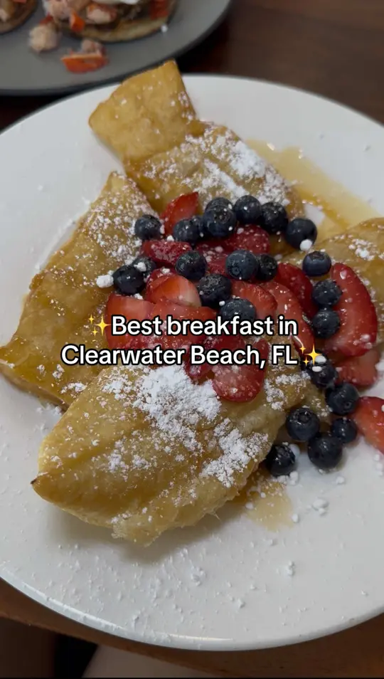 Clear Sky Beachside Cafe in Clearwater showing breakfast, bloody mary, blueberry bellini, beignets and berries, lobster brie bennie with smoked gouda grits, cinnamon bun french toast, video by chefitupwithlani on TikTok