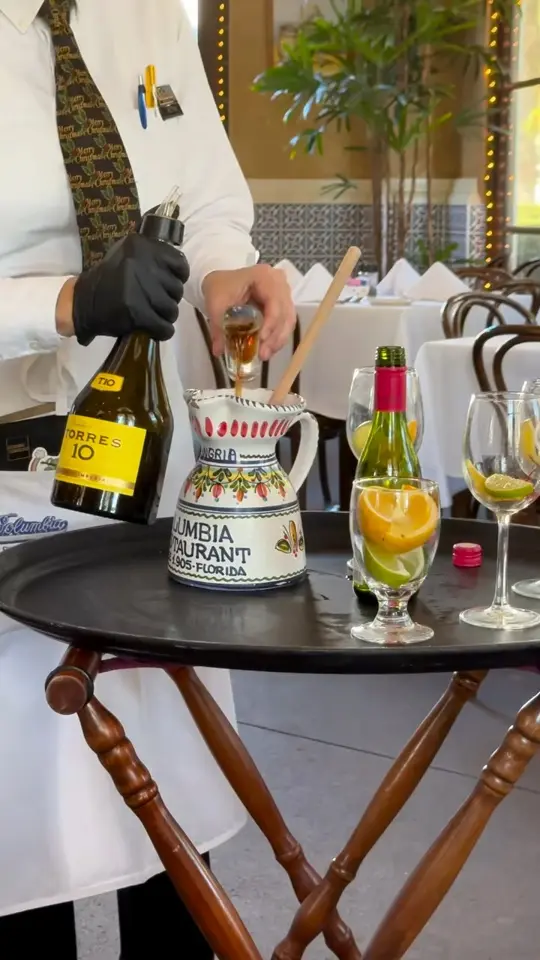 Columbia Restaurant - Ybor City in Tampa showing restaurant, spanish food, cuban food, red sangria pitcher, 1905 salad, video by Columbia Restaurant on Facebook
