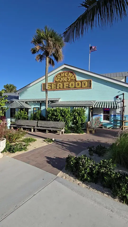 Conchy Joe's Seafood in Jensen Beach showing seafood risotto, sweet potato salmon, alligator bites, tropical cocktails, video by thetreasurecoastfoodie on TikTok