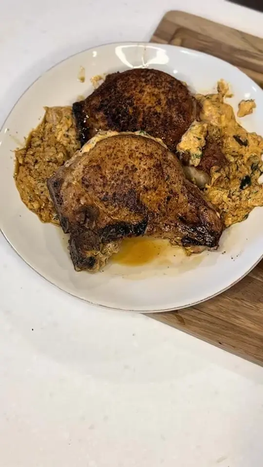 Coosh's Bayou Rouge in Tallahassee showing food, cream cheese and chorizo stuffed pork chop, video by Coosh's Bayou Rouge on Facebook