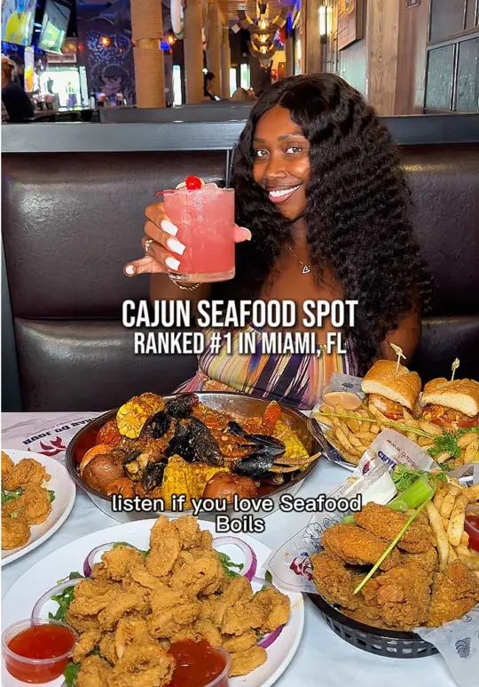 Crab Du Jour Cajun Seafood & Sports Bar in Miami showing review, seafood boil, garlic noodles, jumbo fried shrimp, calamari, sliders, lemon pepper wings, video by theashsarai on TikTok