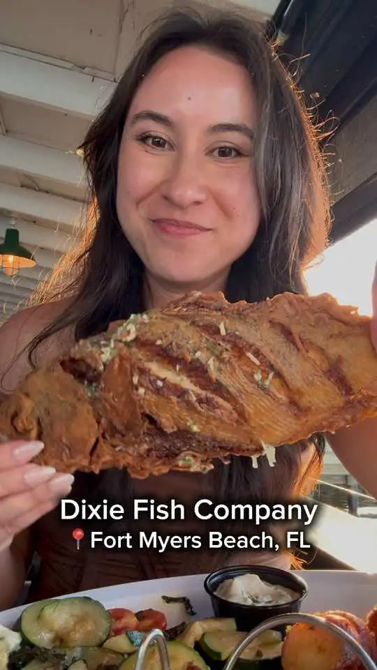 Dixie Fish Company in Fort Myers Beach showing food, crispy whole fried fish, stone claw crab, video by foodiefindsworldwide on TikTok