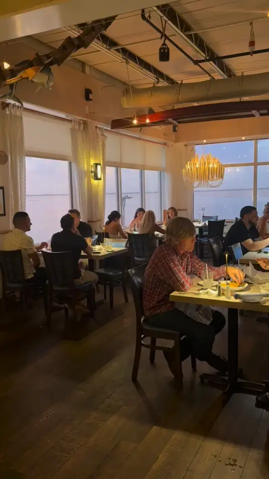 Dry Dock Waterfront Grill in Longboat Key showing atmosphere, dining room, view, video by Dry Dock Waterfront Grill on Facebook