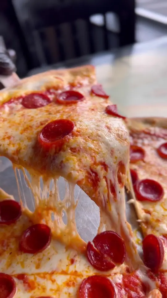 Evio's Pizza & Grill in North Miami showing pizza, cheese pull, video by eviospizza on TikTok