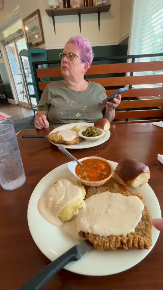 Family Tradition in Woodstock showing food, country fried steak, mashed potatoes and gravy, vegetable beef soup, green beans, video by Brandy Mcneal on Facebook