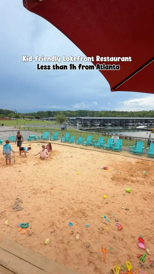 Fish Tales in Flowery Branch showing seafood, burgers, tropical drinks, lake views, live music, sandbox play area, video by The.travel.ksu on Facebook