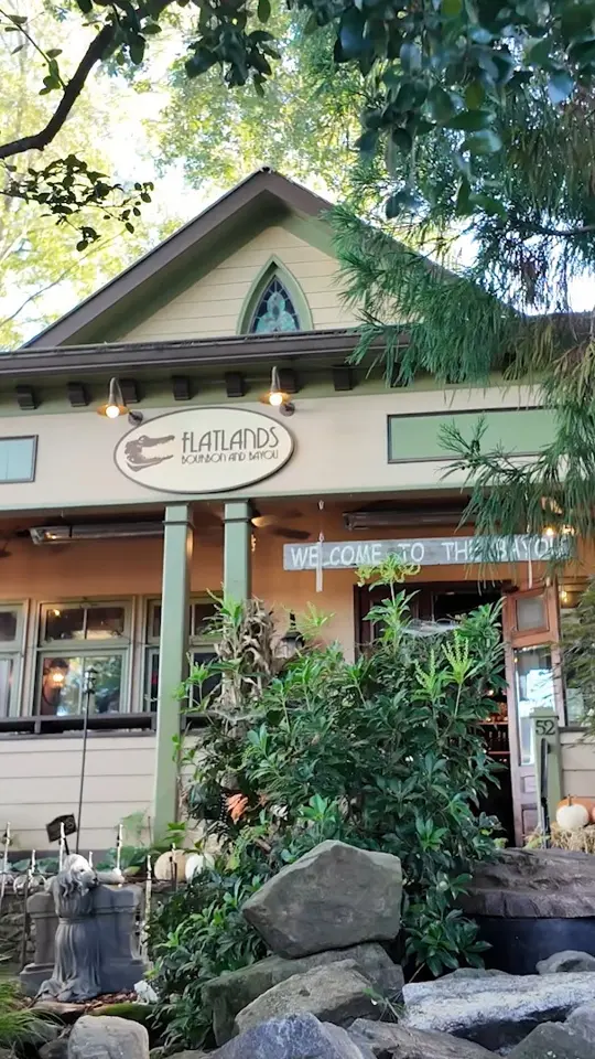 Flatlands Bourbon and Bayou in Alpharetta showing creole cuisine, gumbo, gator bites, beignets, drinks, bayou-inspired atmosphere, video by Awesome Alpharetta, Georgia on Facebook
