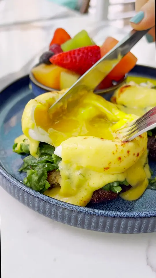 Front Porch Cafe in Miami Beach showing food, crab cake benny, video by The Front Porch Cafe on Facebook