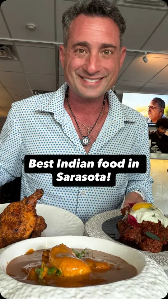 Ganges Restaurant & Bar in Sarasota showing review, butter chicken, ghee brisket, tandoori chicken, video by Foodie Justice on Facebook