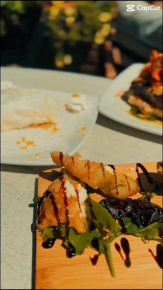Grinds & Wines in Peachtree City showing appetizer, zucchini blossom, main course, pan-seared ribeye, lobster, dessert, lemon meringue, video by Grinds and Wines on Facebook