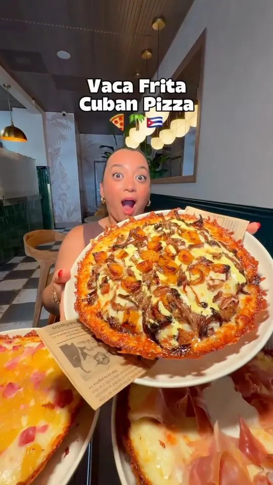 Hakuna Matata Pizzeria in Miami showing pizza, vaca frita pizza, video by Gaby and Johnny on Facebook