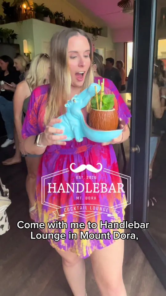 HandleBar in Mount Dora showing review, visit, atmosphere, cocktail, blue hippo drink, video by sunshineandkeylimeblog on TikTok