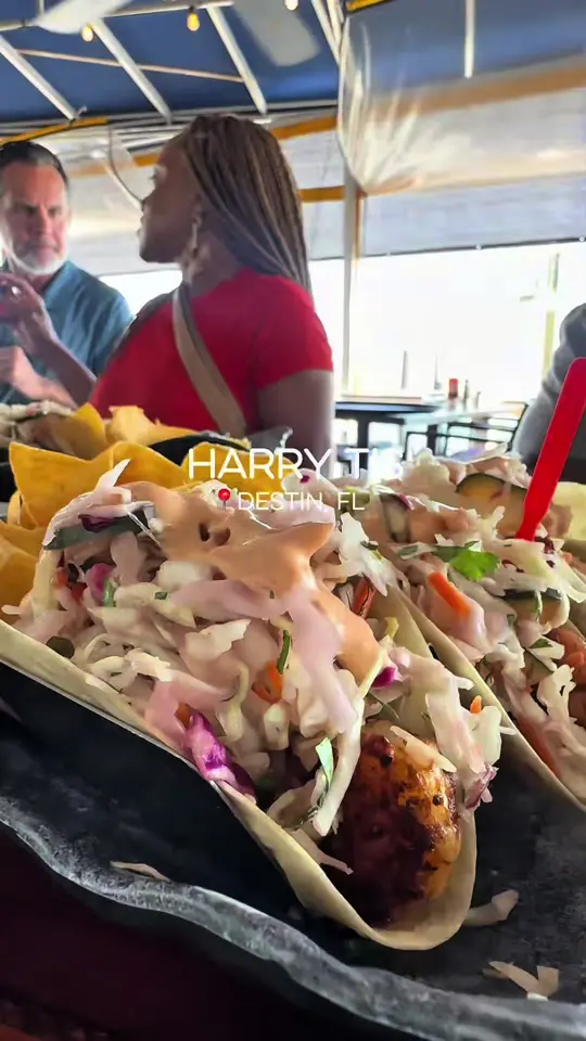 Harry T's Lighthouse in Destin showing review, visit, tacos, seafood mac & cheese, blackened halibut, shrimp & grits, video by thebrownbelle on TikTok
