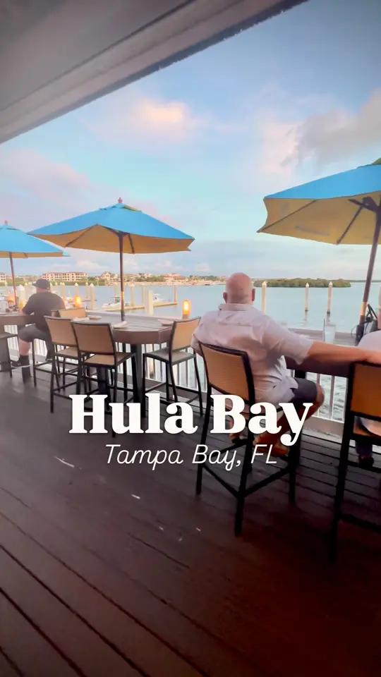 Hula Bay Club in Tampa showing seafood, sushi, burgers, tropical cocktails, waterfront views, video by Things To Do Tampa Bay on Facebook