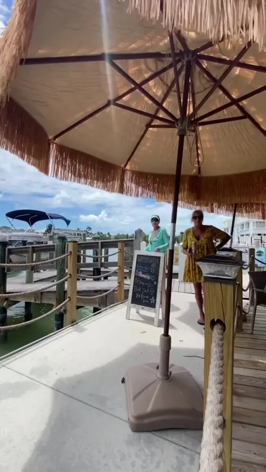 Island Gypsy Cafe & Marina Bar in Naples showing outdoor dining, marina, boat docking, video by Island Gypsy on Facebook