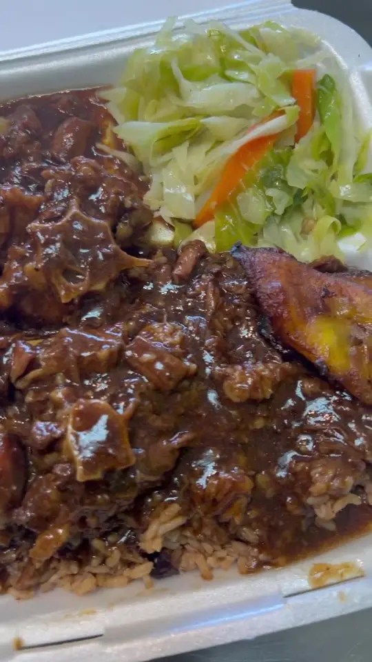 Island Spice Grill and Wings in Douglasville showing food, oxtails with rice and peas and cabbage, video by Island Spice Grill and Wings on Facebook