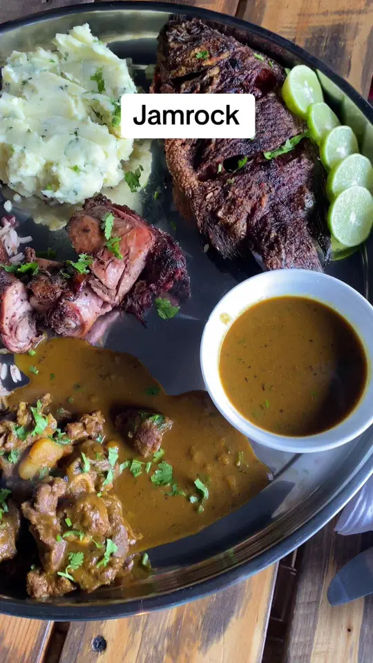 Jam Rock in Deltona showing food, jerk chicken, curry goat, fish, mashed potatoes, video by khakni on TikTok