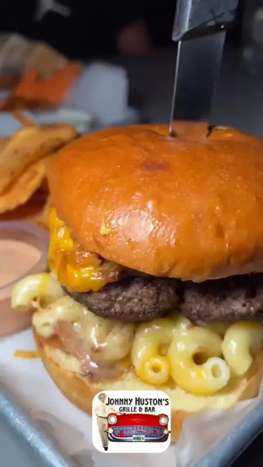 Johnny Huston's Grille & Bar in Navarre showing food, mac & cheese burger, video by Johnny Huston's Grille and Bar on Facebook