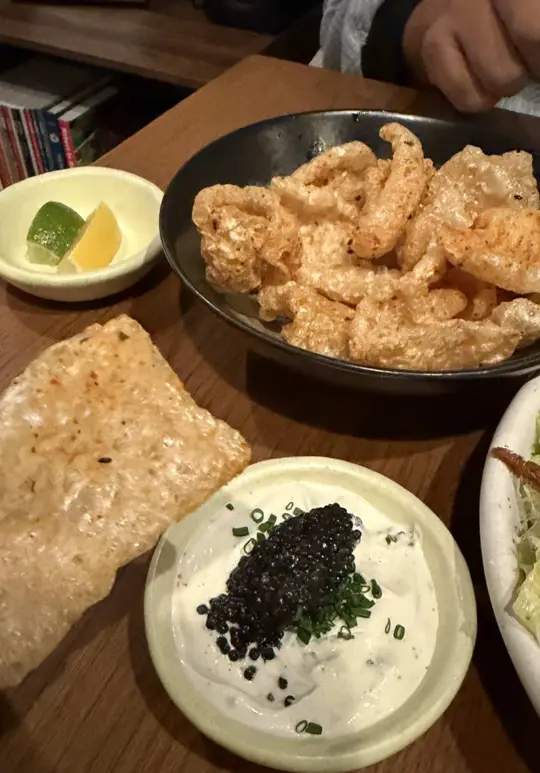 Kojin in Coral Gables showing food, chicharrones topped with caviar, scallop ravioli, video by miamicrowd on TikTok