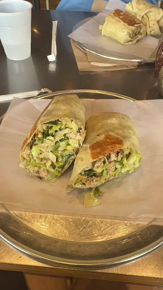 Lazy Moon Pizza in Orlando showing food, chicken caesar wrap, video by hilaryheartstravel on TikTok