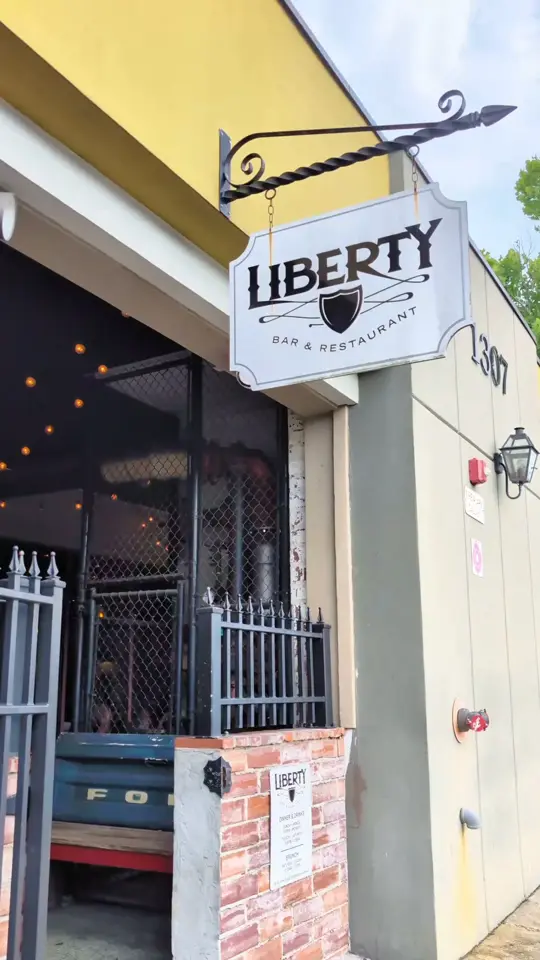 Liberty Bar & Restaurant in Tallahassee showing cocktail, pub fare, scotch egg, duck confit mac & cheese, nduja-stuffed flounder, three-course menu, video by Visit Tallahassee on Facebook