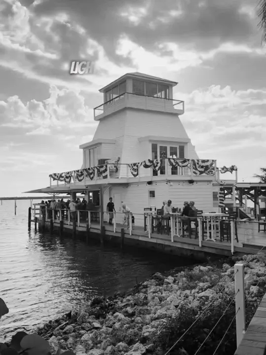 Lighthouse Grill and Tiki Bar in Englewood showing drinks, waterfront views, live music, island vibes, video by theswankytraveler on TikTok