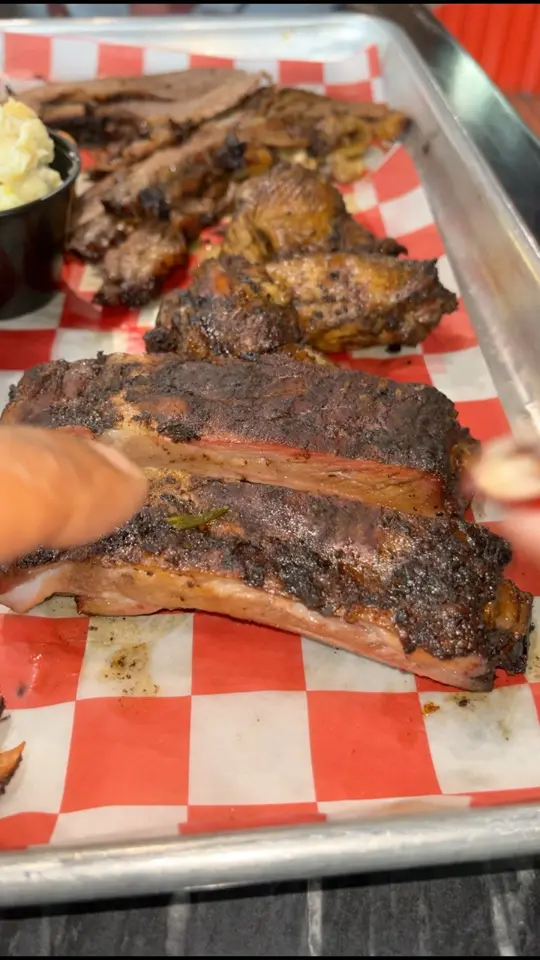 Ludz BBQ & Mattie's Desserts in Cocoa Beach showing jerk bbq tray, video by The Hughley’s on Facebook