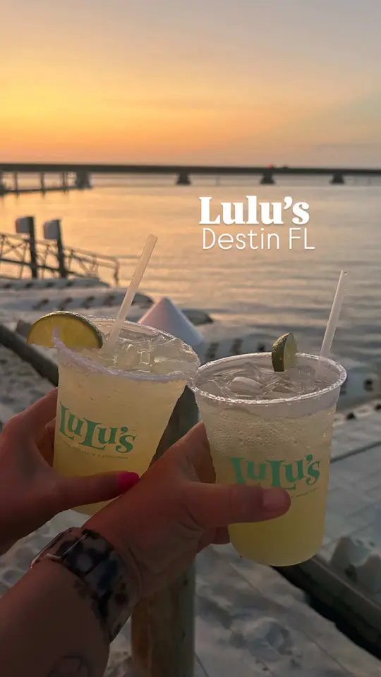 Lulu's Destin in Destin showing review, waterfront atmosphere, sandy beach play area, arcade, live music, bay front views, fresh seafood, burgers, kid-friendly favorites, allergy-friendly opti, video by kristenbythecoast on TikTok