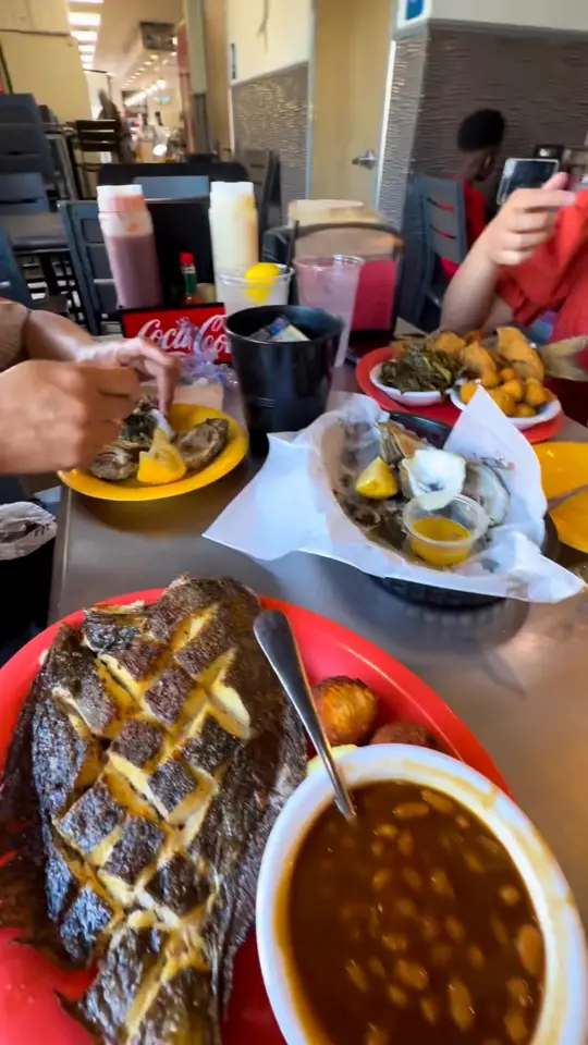 Maria's Olde East Hill Grill in Pensacola showing steamed fish, grilled oysters, fried whole fish, shrimp plate, video by Sampaguita La-iyana on Facebook