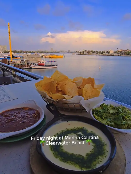 Marina Cantina in Clearwater showing cocktail, margarita / food, chips / food, guacamole / food, queso / atmosphere, rooftop party, video by clearwaterbeachhotspots on TikTok