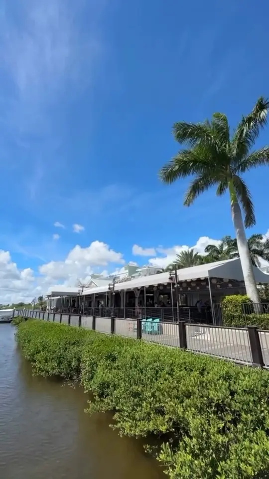Outriggers Tiki Bar & Grille in New Smyrna Beach showing waterfront vibes, tiki bar, grille, video by Visit New Smyrna Beach on Facebook
