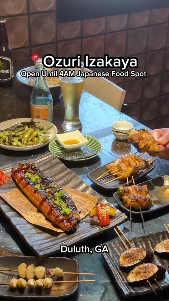 Ozuri Izakaya in Duluth showing visit, date night, beer, sake, edamame, fresh uni, shoyu ramen, yakitori, enoki & bacon, pork belly, garlic, green onion with bacon, video by mis.shelly on TikTok