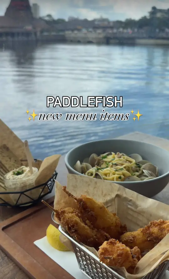 Paddlefish Restaurant in Lake Buena Vista showing elevated seafood, stunning views, crab boursin dip, lobster corn dogs, linguine and clams, shrimp pasta, video by _adatewithkait on TikTok
