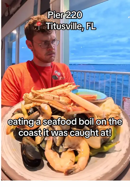 Pier 220 Seafood and Grill in Titusville showing food review, fried grouper, conch fritters, seafood boil, crab and blackened shrimp tacos, tuxedo bomb cake, pineapple coconut princess cake, video by itsryansreview on TikTok