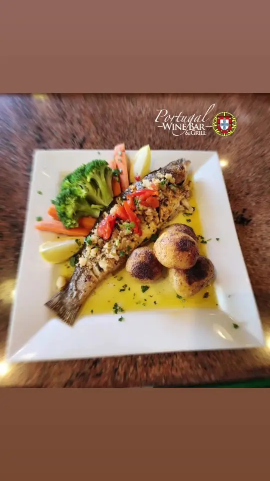 Portugal Wine Bar & Grill in Palm Coast showing food, grilled sea bass, video by portugalwinebarandgrill on TikTok