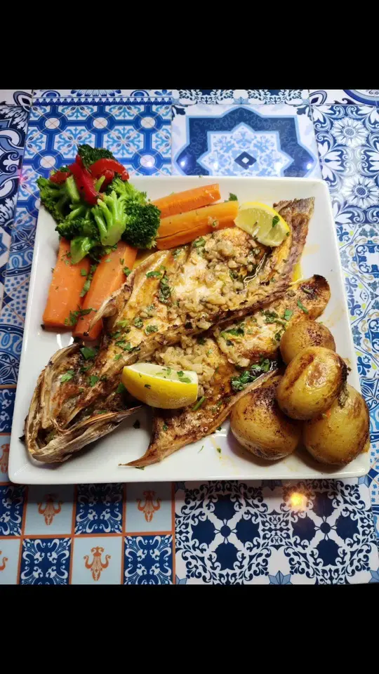 Portugal Wine Bar & Grill in Palm Coast showing food, grilled branzino, video by portugalwinebarandgrill on TikTok