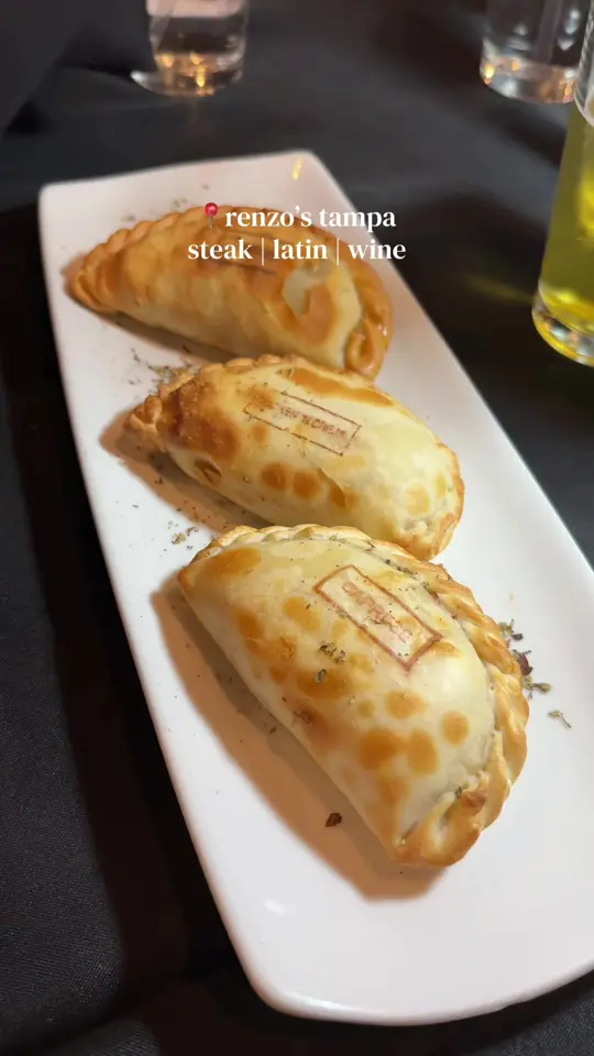 Renzo's in Tampa showing latin steakhouse, tomahawk steaks, parrillas, wine, girls night, date night, video by wanderwithemely on TikTok