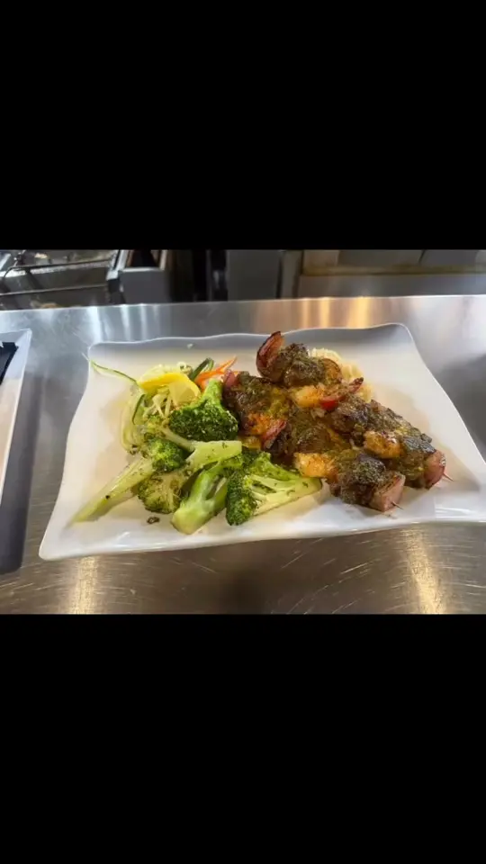 Ricky T's Bar & Grille in Treasure Island showing food, surf and turf, video by Ricky T's on Facebook