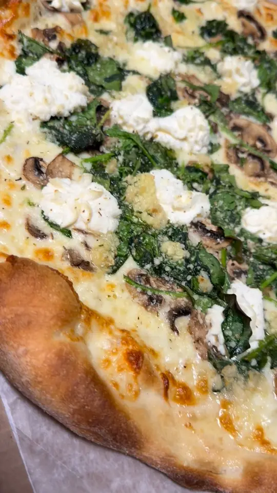 Rico's Pizzeria & Pasta House in Bradenton showing food, white pizza with mushrooms and spinach, video by Rico's Pizzeria & Pasta House on Facebook